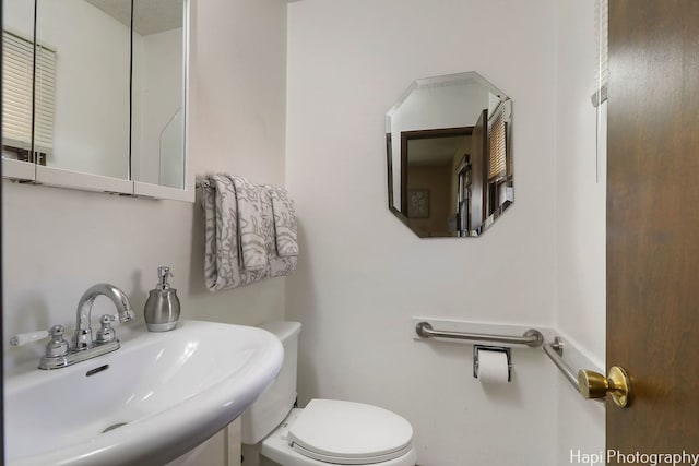 bathroom with toilet and a sink