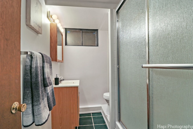 full bath featuring toilet, a shower stall, vanity, and tile patterned floors