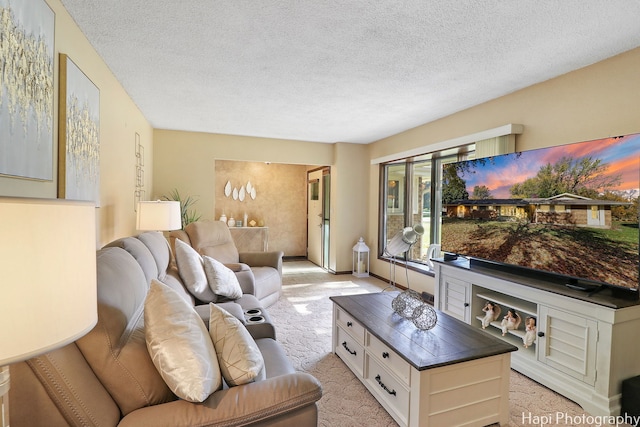 living area with light carpet and a textured ceiling