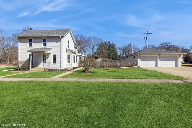 exterior space with a shingled roof, a lawn, an attached garage, fence, and driveway