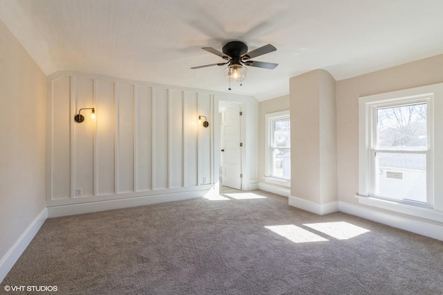 unfurnished room with carpet flooring and baseboards