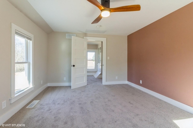 unfurnished bedroom with light carpet, ceiling fan, visible vents, and baseboards