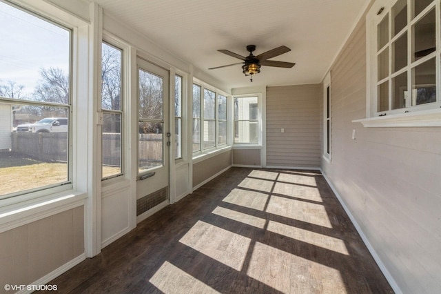 unfurnished sunroom with a ceiling fan