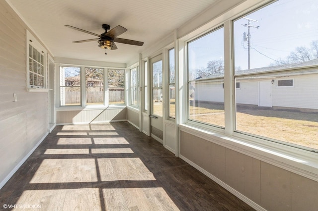 unfurnished sunroom featuring ceiling fan