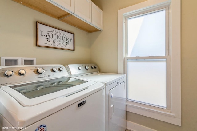 laundry area featuring a wealth of natural light, separate washer and dryer, and cabinet space