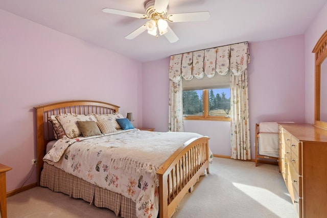 bedroom featuring baseboards, a ceiling fan, and light colored carpet