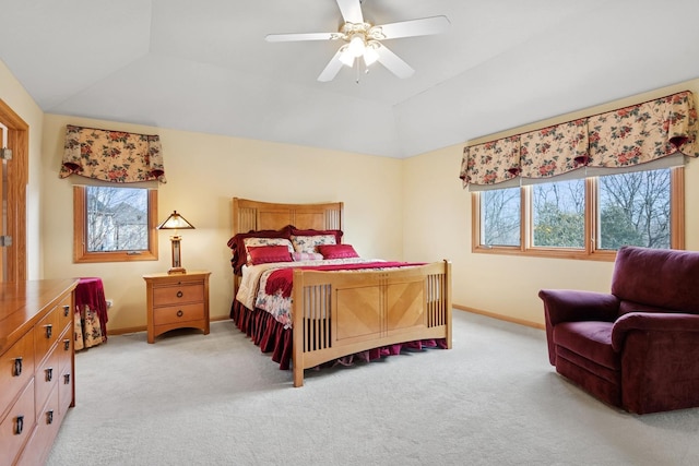 bedroom featuring light carpet, baseboards, and lofted ceiling