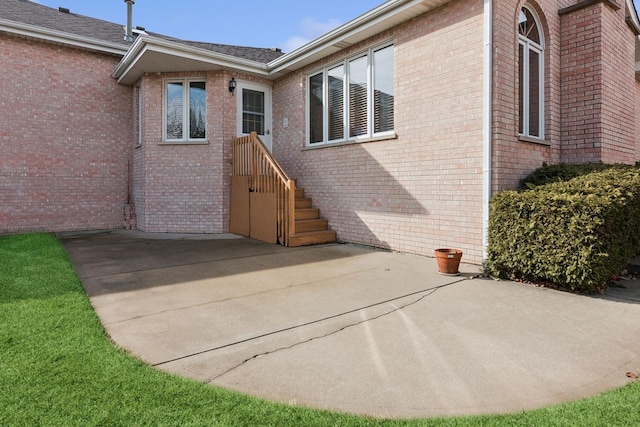 back of house featuring a patio and brick siding