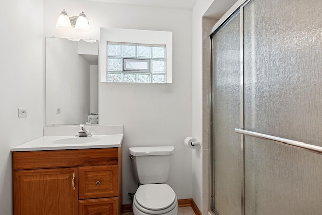 full bath featuring toilet, a shower stall, and vanity