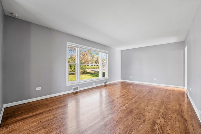 200 S Roselle Rd, Roselle, IL 60172 - empty room featuring wood finished floors, baseboards, and a smoke detector