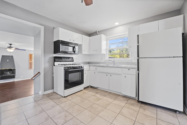 200 S Roselle Rd, Roselle, IL 60172 - kitchen with white appliances, a ceiling fan, a sink, light countertops, and light tile patterned floors