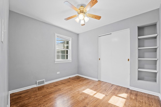200 S Roselle Rd, Roselle, IL 60172 - unfurnished bedroom featuring light wood finished floors, a closet, baseboards, and ceiling fan