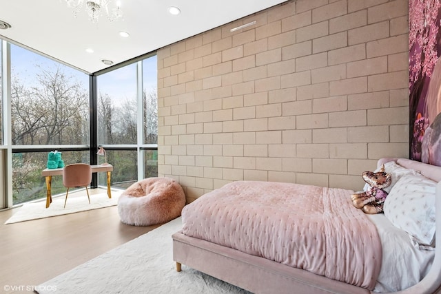 bedroom featuring recessed lighting, wood finished floors, and floor to ceiling windows