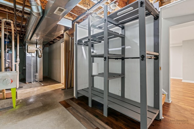 unfinished basement with heating unit and visible vents