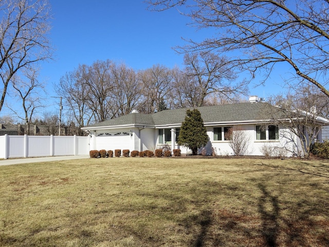 view of front of property featuring a garage, a chimney, fence, and a front lawn