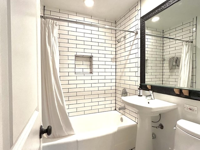 bathroom featuring toilet and shower / tub combo with curtain