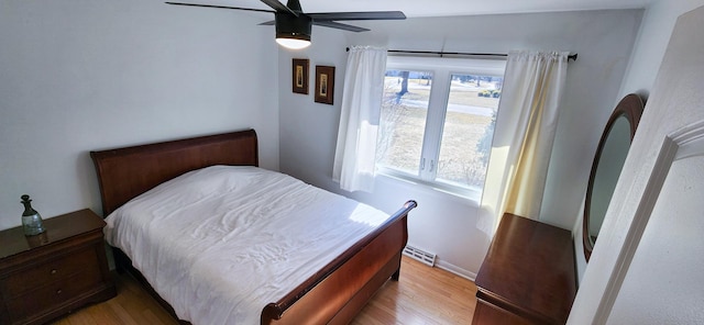 bedroom with light wood finished floors, ceiling fan, and visible vents