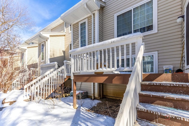 snow covered deck featuring stairs