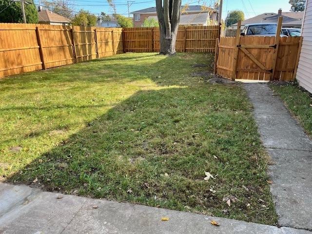 view of yard featuring a gate and a fenced backyard