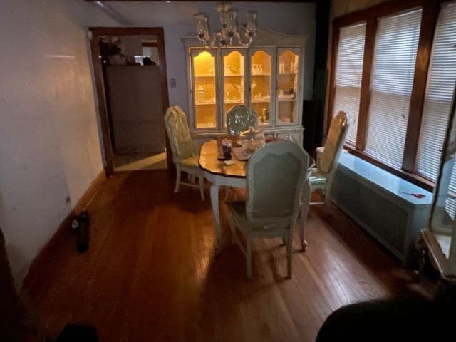 dining room with a notable chandelier and wood finished floors