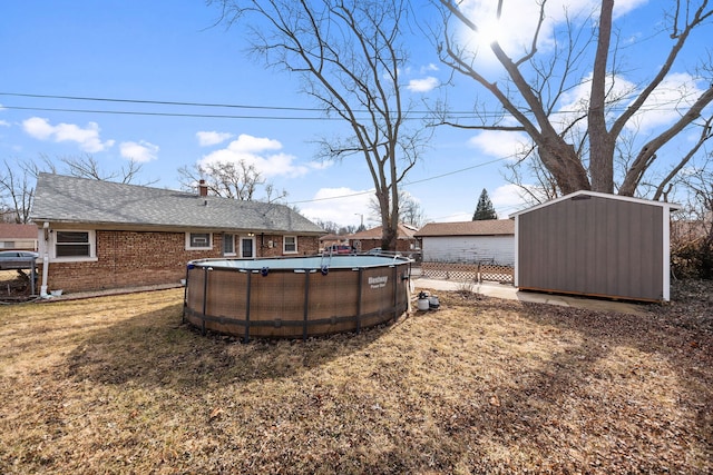 view of yard with a storage shed, an outbuilding, and an outdoor pool