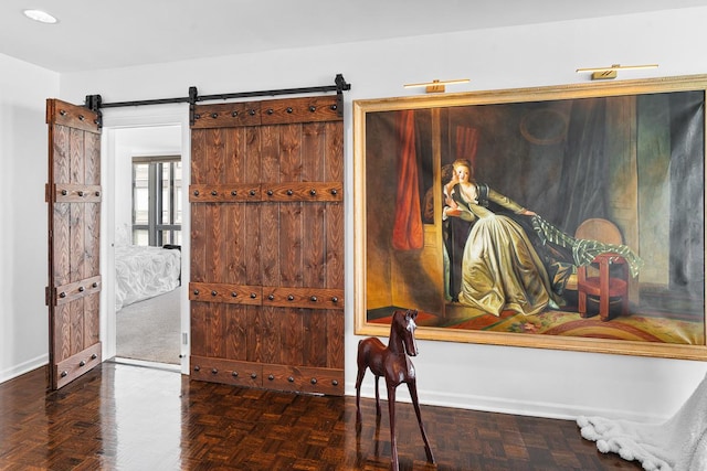 foyer featuring baseboards and a barn door