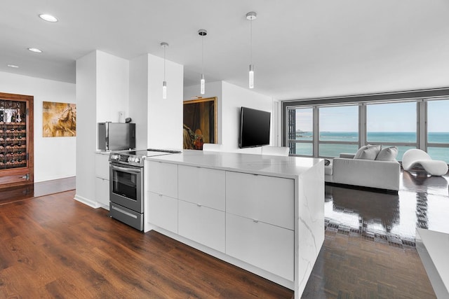 kitchen featuring electric range, white cabinets, modern cabinets, dark wood-type flooring, and decorative light fixtures