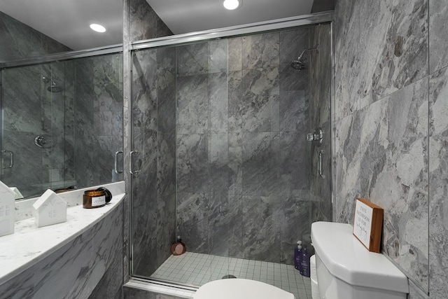 bathroom featuring a stall shower and toilet