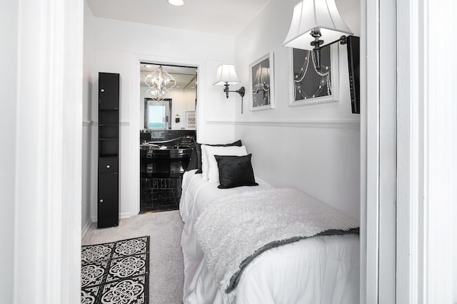 carpeted bedroom featuring a notable chandelier