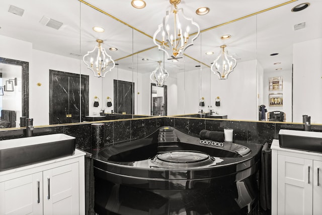 bathroom featuring a chandelier, recessed lighting, and vanity