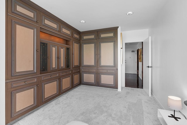 unfurnished room with baseboards and light colored carpet