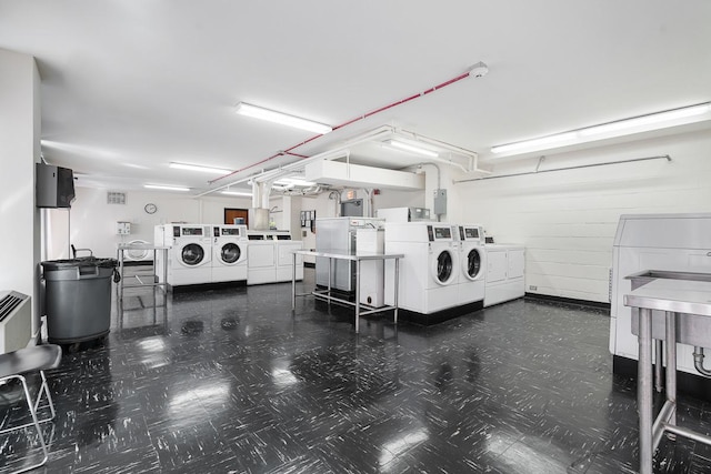 community laundry room featuring washing machine and dryer and tile patterned floors