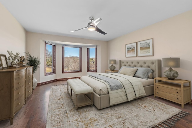 bedroom featuring ceiling fan, baseboards, and wood finished floors