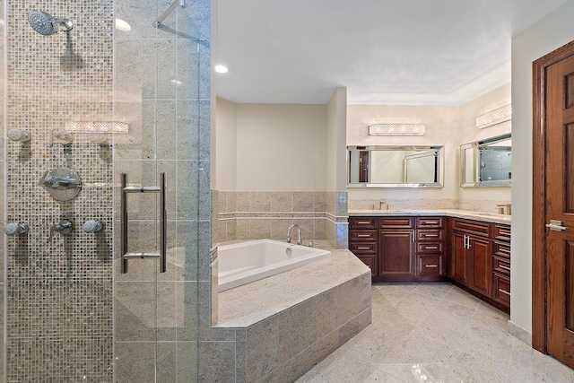 bathroom featuring a stall shower, a garden tub, a sink, and double vanity