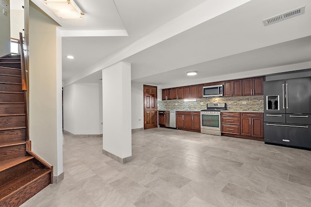 kitchen with stainless steel appliances, visible vents, baseboards, light countertops, and decorative backsplash