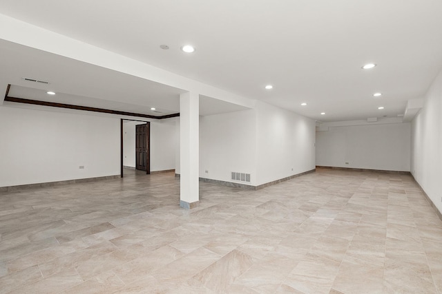 finished below grade area featuring baseboards, visible vents, and recessed lighting