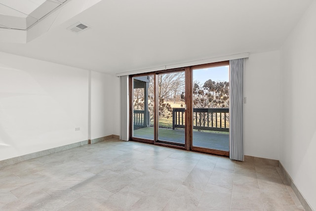 spare room featuring visible vents and baseboards