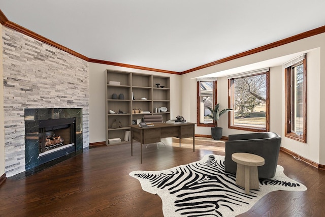 office area featuring crown molding, a fireplace, baseboards, and wood finished floors