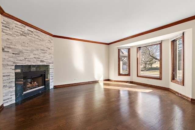 unfurnished living room with a fireplace with flush hearth, crown molding, baseboards, and wood finished floors