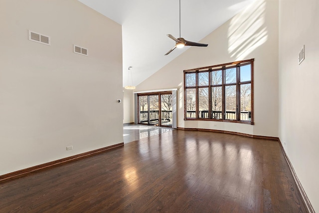 unfurnished living room with a ceiling fan, visible vents, baseboards, and wood finished floors