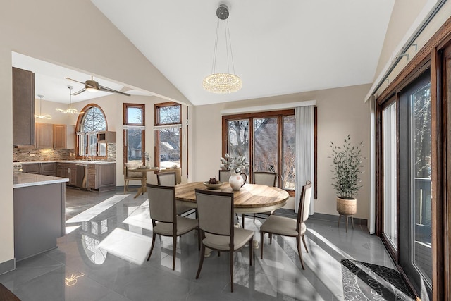 dining room with lofted ceiling, marble finish floor, a ceiling fan, and baseboards