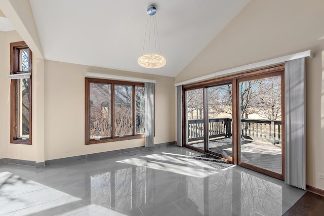 unfurnished dining area featuring marble finish floor, baseboards, and high vaulted ceiling