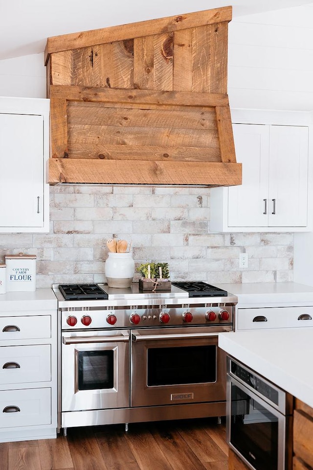 kitchen featuring range with two ovens, light countertops, and white cabinetry