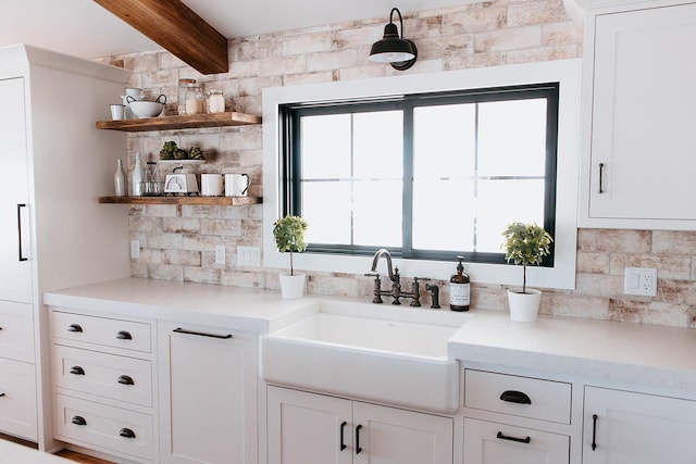 bar featuring backsplash, a sink, and beamed ceiling