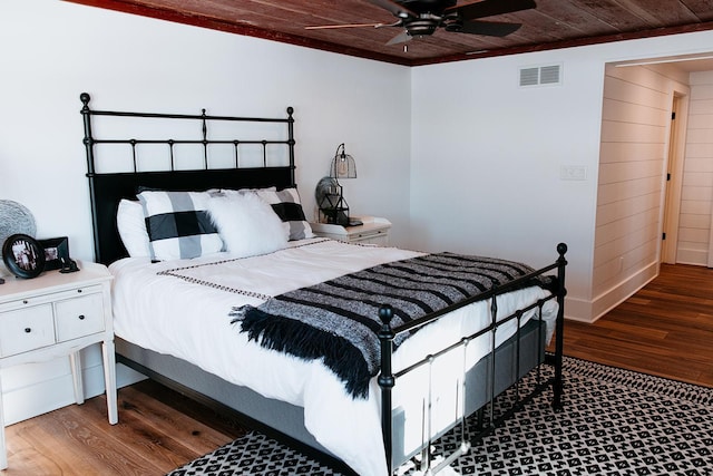 bedroom featuring ceiling fan, wooden ceiling, wood finished floors, and visible vents