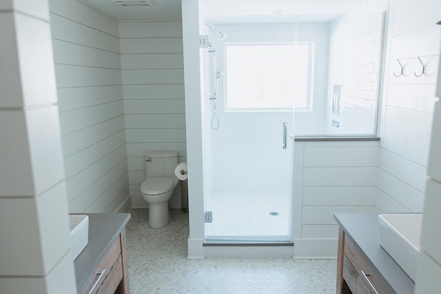 full bathroom featuring visible vents, toilet, a stall shower, vanity, and tile patterned flooring