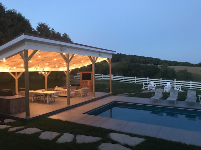 view of swimming pool featuring fence, a deck, and a fenced in pool