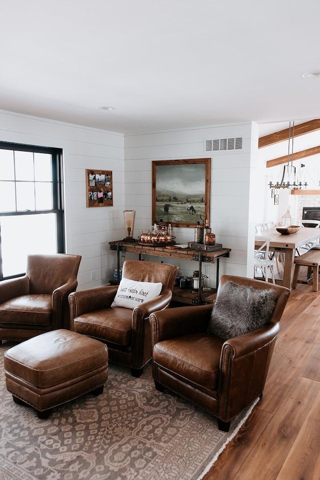 living room with wood finished floors and visible vents