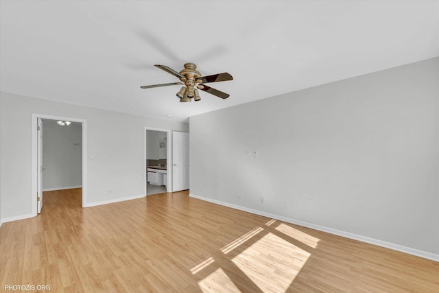 unfurnished room with light wood-type flooring, a ceiling fan, and baseboards