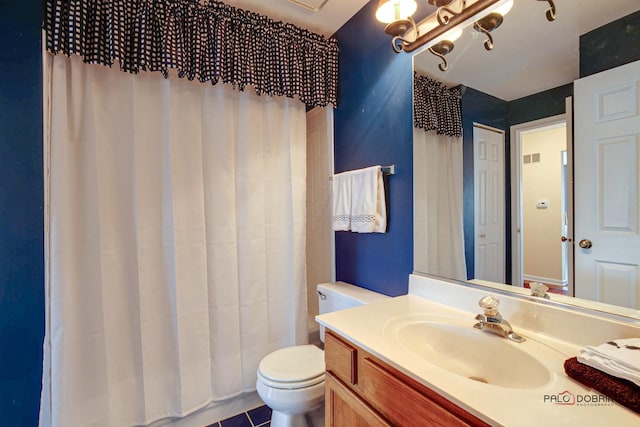 bathroom with curtained shower, vanity, and toilet